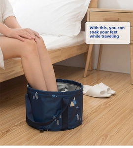Detail of portable blue folding foot soak basin with reinforced black handles and waterproof lining