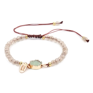 Handmade braided bracelet featuring a 4mm pink stone and green natural quartz centerpiece