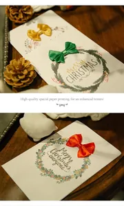 Detail of Christmas greeting card featuring festive wreath and handmade silk ribbon bow