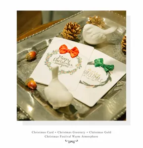 Detail of Christmas cards with red and green bows on a vintage festive background