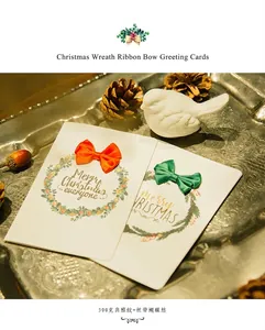 Detailed view of Christmas greeting cards with ribbons on a 300g textured paper base