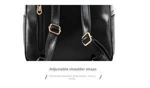 Detail of adjustable and detachable leather straps with gold metal buckles on a black backpack