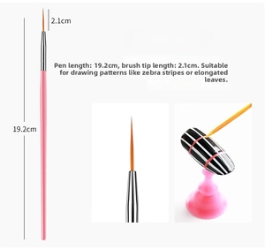 Detail view of professional nail art liner brush with long orange fibers and pink handle