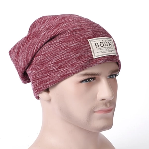 Close-up of a burgundy knit slouchy beanie featuring a rectangular Rock fabric patch