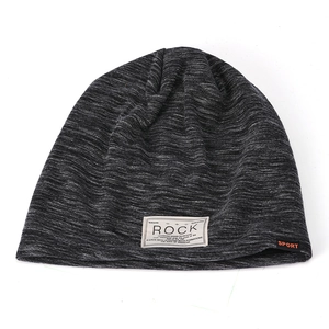 Detail of dark heather grey knitted slouchy beanie with ROCK textile patch and sport tag
