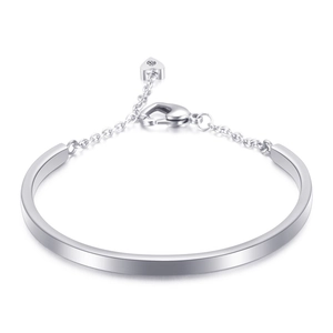 Polished silver U-shaped stainless steel bangle with a delicate heart charm and lobster clasp