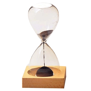 Magnetic hourglass with black iron powder and wooden base on clear background