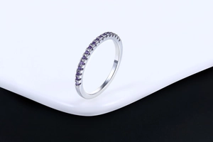 Close-up of elegant rose gold plated ring featuring a row of micro-set purple zircons