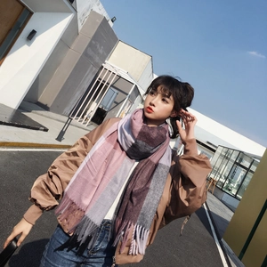 Close-up of pastel plaid scarf with soft fringe details and thick knit texture