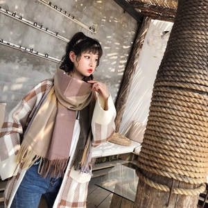 Close-up of thick plaid tassel scarf in beige, lilac, ginger, and dark coffee colors