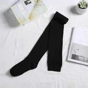 Detail of black over-the-knee cotton socks with reinforced ribbed cuffs on white textile