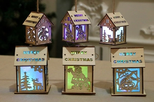 Detail of wooden LED Christmas houses featuring reindeer and Santa Claus carvings