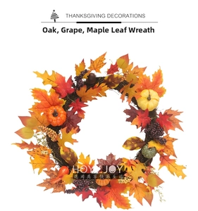 Detail view of Thanksgiving autumn wreath with maple leaves, grapes, and mini pumpkins