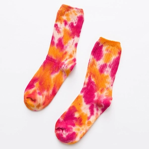 Pink and orange tie-dye mid-calf athletic socks with ribbed cuffs and knitted texture