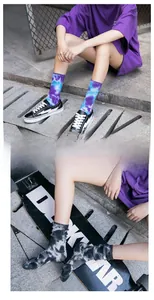 Close-up of purple and grey tie-dye mid-calf crew socks worn in a street style setting