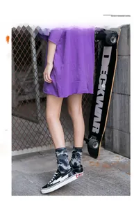 Close-up of street style tie-dye crew socks paired with black and white skate shoes