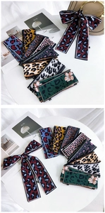 Detailed view of various leopard print and floral skinny scarves for bags or hair