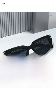 Detail of vintage cat eye sunglasses featuring gold hollow chain design on metal temples
