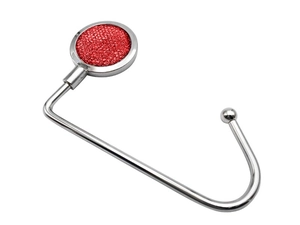 Close-up of a red glitter circular metal desk hook for bags with a polished finish