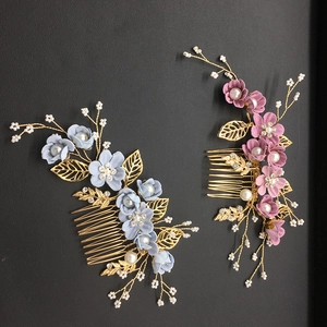 Detail showing blue and pink floral hair combs with pearls and rhinestones on gold tines