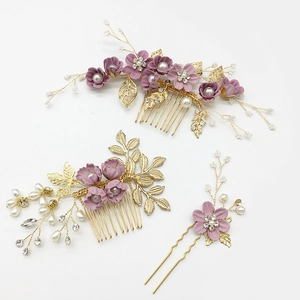 Detailed view of handmade purple floral hairpins and combs with pearls and gold leaves