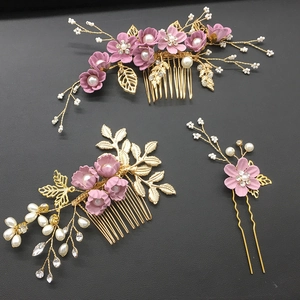 Detailed set of golden bridal hair combs and pin with pink fabric flowers and white pearls