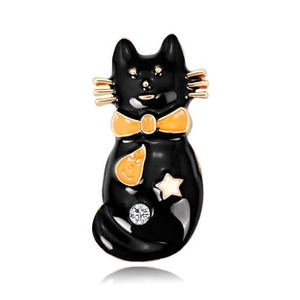 Detailed view of a black cat enamel brooch with golden bow and crescent moon pattern