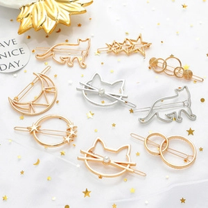 Close-up of gold and silver geometric hair clips with stars, moons, and pearls