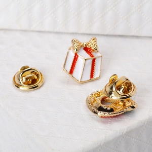 Detail of Christmas tree brooch pins with butterfly clutch and gold plated alloy texture