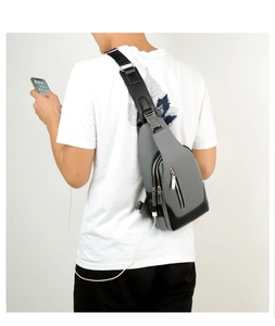 Men's Oxford chest bag detail showing the external USB charging port and crossbody style