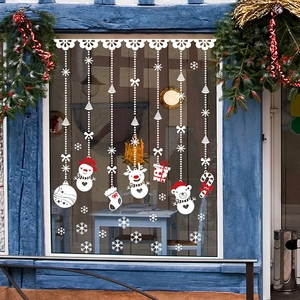 Christmas snowman and reindeer static window decals on a blue glass window pane