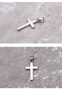 Detailed close-up showing front and side views of a polished silver cross pendant