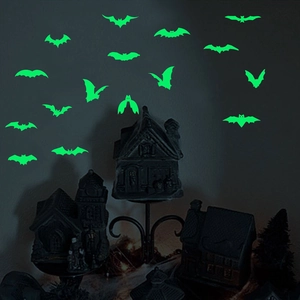 Detailed view of luminous green bat stickers glowing in the dark for Halloween wall decor