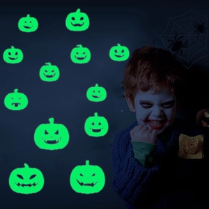 Luminous green Halloween pumpkin stickers glowing in the dark for festive wall decoration