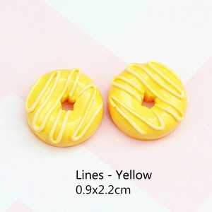 Close-up of 0.9x2.2cm yellow resin donut charms with decorative icing for DIY jewelry