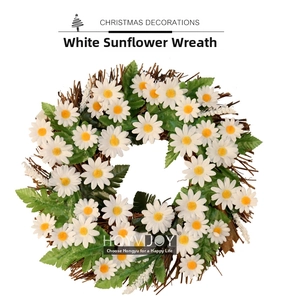Detailed close-up of a white daisy Christmas wreath with green leaves on a twig base