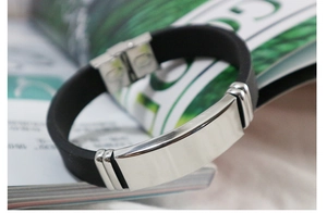 Close-up of black rubber ID bracelet with a polished silver stainless steel rectangle bar