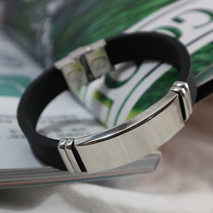 Men's black silicone bracelet with a polished blank metal plate and secure fold-over clasp