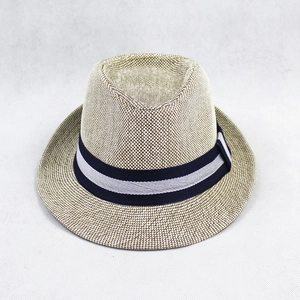 Detail of light brown straw fedora featuring a blue and white striped ribbon band