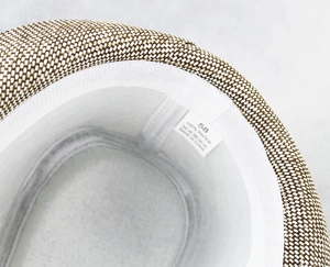 Detail of the 100% paper straw hat interior featuring the size 58 label and sweatband