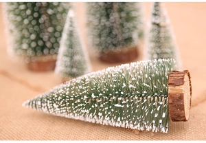 Macro detail of mini sisal Christmas tree with snow spray and natural wooden base