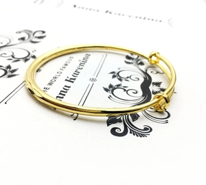 Detail of adjustable 18K gold plated bangle with smooth sliding clasp mechanism