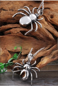 Macro detail of a polished spider pendant on a twisted rope chain and natural wood background