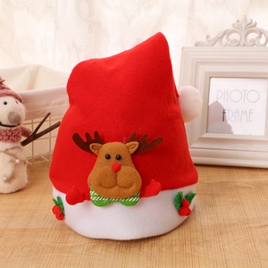 Detail of red felt Christmas hat featuring a brown reindeer doll and green holly leaves