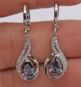 Macro view of teardrop rainbow topaz earrings with halo diamonds and lever-back clasp