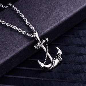 Macro shot of retro stainless steel anchor pendant with detailed rope carving on chain