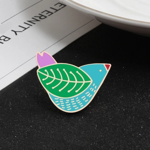 Artistic bird enamel brooch featuring colorful leaf patterns and gold plating