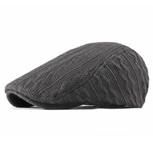 Dark grey knitted ivy cap for winter with thick cable stitch texture and sleek flat profile