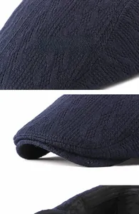 Close-up of cable knit texture and reinforced brim on this navy blue newsboy cap