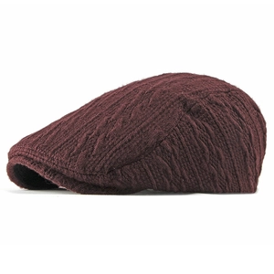 Winter knit newsboy cap in dark burgundy wool blend featuring classic cable-knit texture